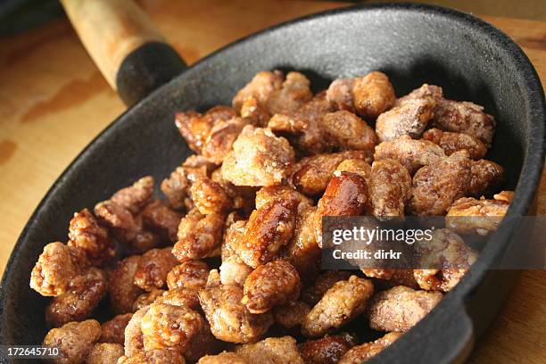 close up of fried almonds on a flying pan - glazen pot stock pictures, royalty-free photos & images