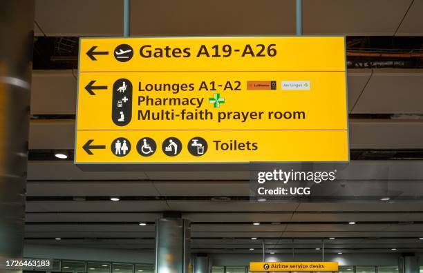 An illuminated information sign within Terminal 2 at London Heathrow Airport, UK.