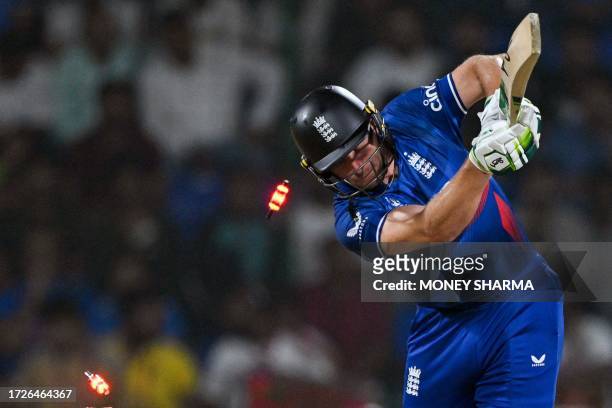 England's captain Jos Buttler is clean bowled during the 2023 ICC Men's Cricket World Cup one-day international match between England and Afghanistan...