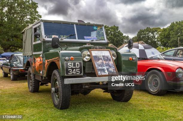 Series 1 Land Rover car with its sturdy chassis and green aluminum body on display at a classic car show in Storrington, West Sussex, UK.