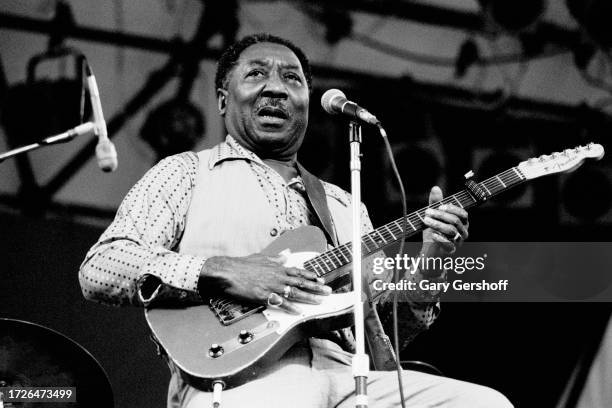 American Blues musician Muddy Waters , on electric guitar, performs onstage during the Dr Pepper Summer Music Festival in Central Park, New York, New...