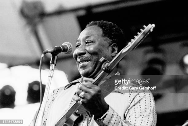 American Blues musician Muddy Waters , on electric guitar, performs onstage during the Dr Pepper Summer Music Festival in Central Park, New York, New...