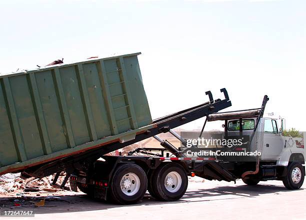 city truck unloading dumpster of trash - afvalcontainer stockfoto's en -beelden