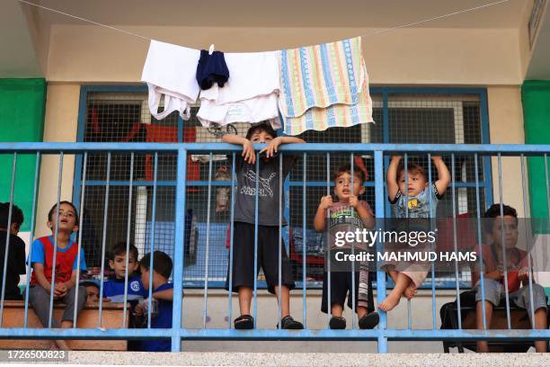 Graphic content / Children of internally displaced Palestinians who took refuge in a United Nations-run school gather on the balcony of a classroom...