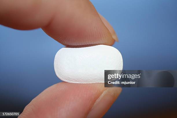 white pill - pinching stock pictures, royalty-free photos & images