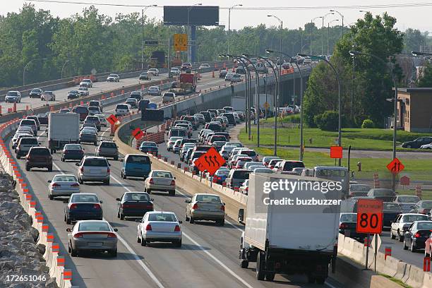 traffic during rush hour on a highway under construction - quebec road stock pictures, royalty-free photos & images