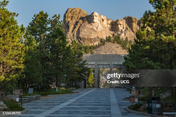 Carved granite busts of George Washington, Thomas Jefferson, Theodore "Teddy" Roosevelt and Abraham Lincoln above the Avenue of Flags at the entrance...