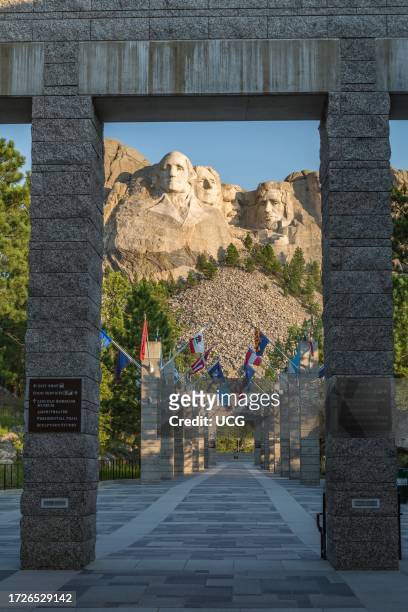Carved granite busts of George Washington, Thomas Jefferson, Theodore "Teddy" Roosevelt and Abraham Lincoln above the Avenue of Flags at the entrance...