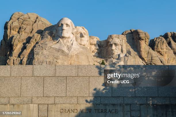 Carved granite busts of George Washington, Thomas Jefferson, Theodore "Teddy" Roosevelt and Abraham Lincoln over the wall of the Grand View Terrace...