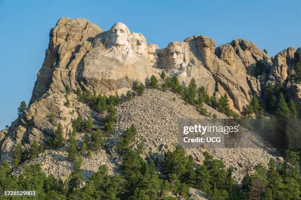 Carved granite busts of George Washington, Thomas Jefferson, Theodore "Teddy" Roosevelt and Abraham Lincoln at Mount Rushmore National Monument near...