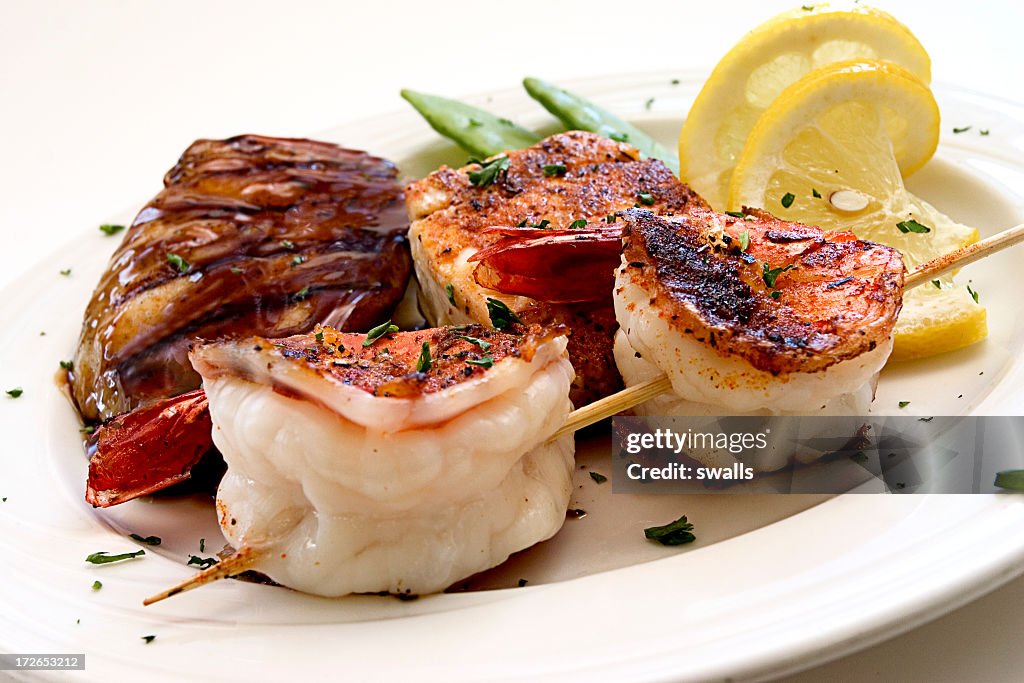 A variety of cooked seafood with garnishes