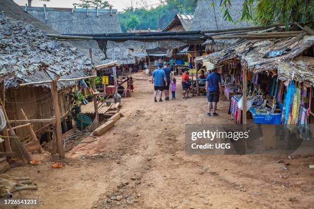 American tourists walking through the Long Neck Karen tribe area of the Union of Hill Tribe Villages outside of Chiang Rai in the Nanglae District of...