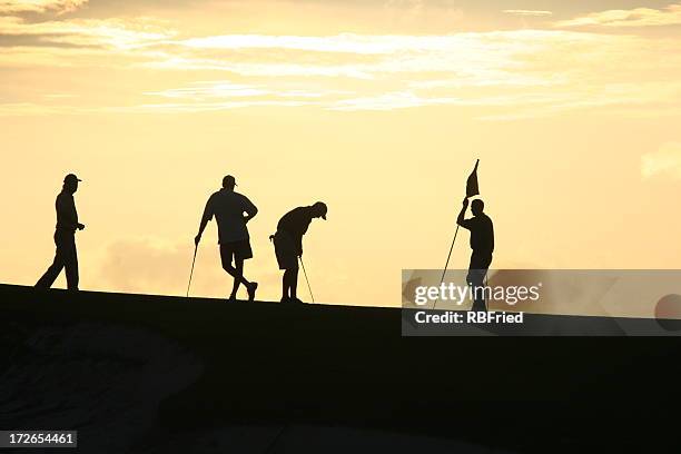 golfers at sunset 2 - four people silhouette stock pictures, royalty-free photos & images