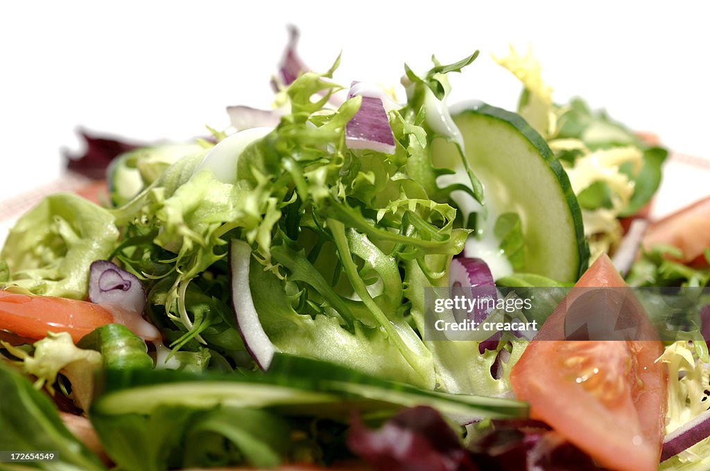 Bowl of mixed salad against a white background