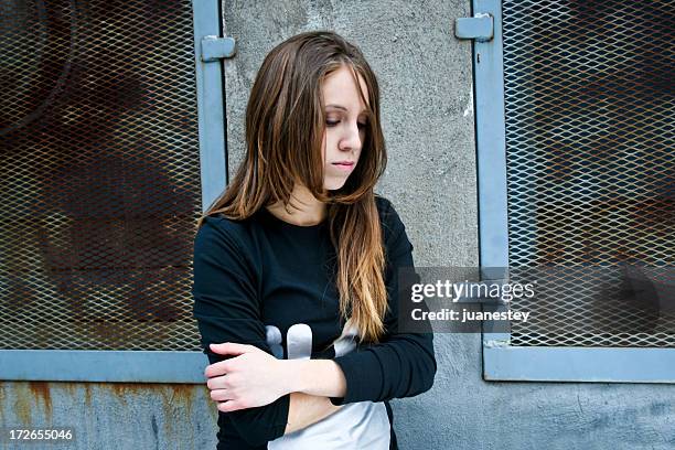 a sad teenager girl crossing her arms - passed out girl stock pictures, royalty-free photos & images