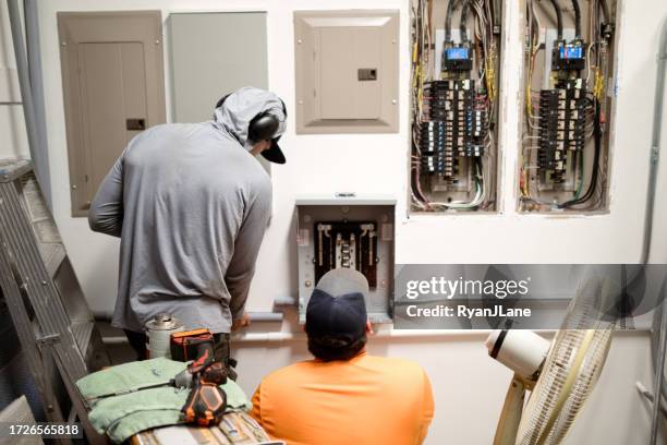 electricians working on panel for solar power - distribution board stock pictures, royalty-free photos & images