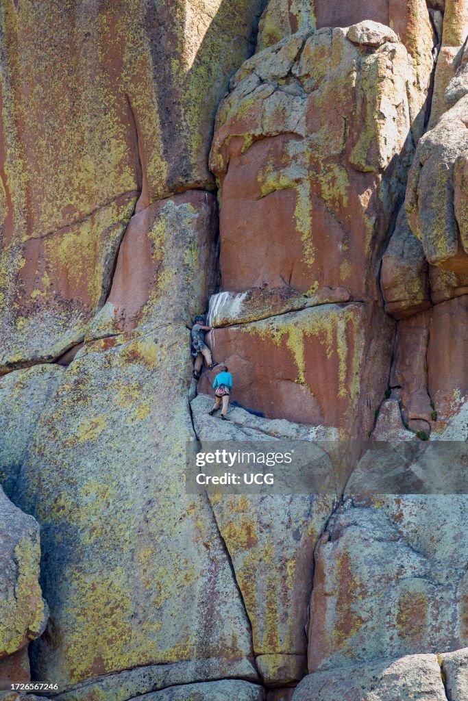 Man and woman rock climbing in the Vedauwoo Recreation Area of Medicine Bow National Forest in Wyoming