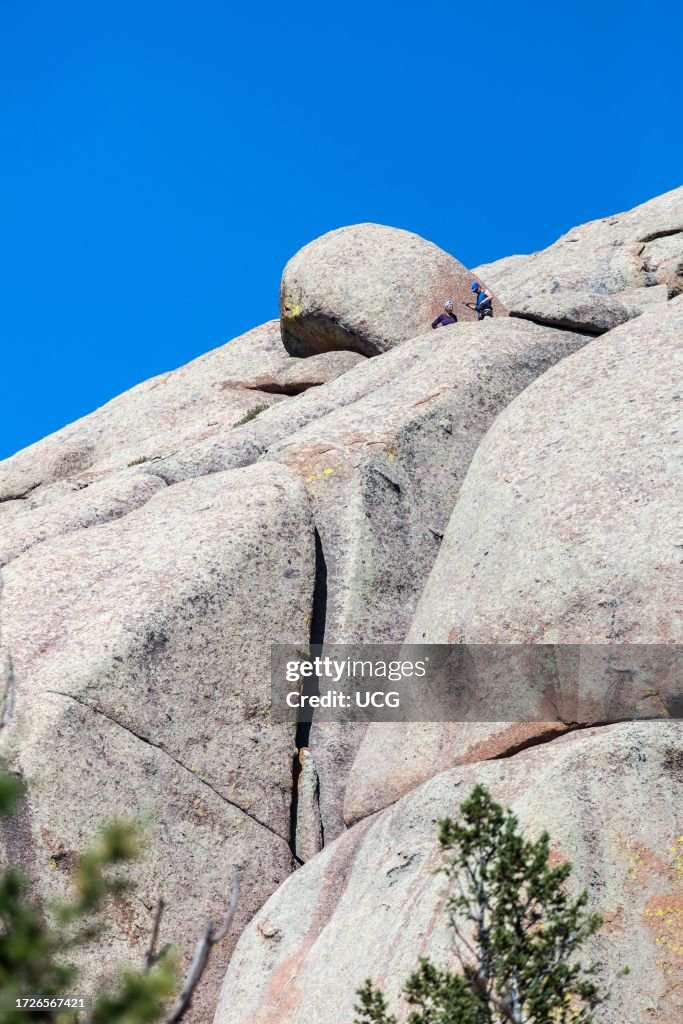 Man and woman rock climbing in the Vedauwoo Recreation Area of Medicine Bow National Forest in Wyoming