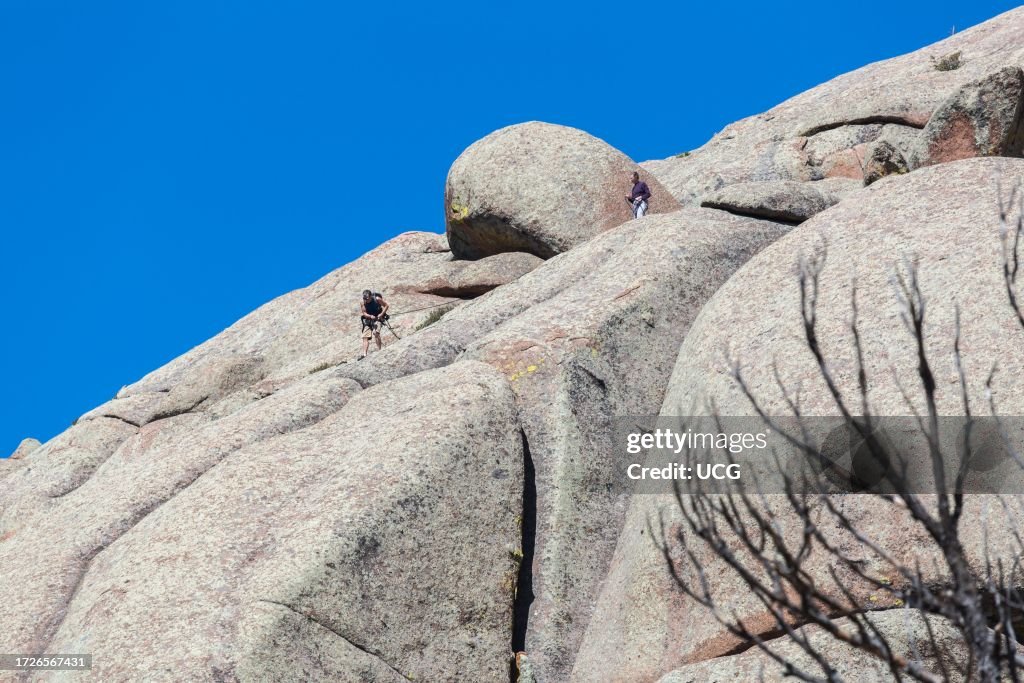Man and woman rock climbing in the Vedauwoo Recreation Area of Medicine Bow National Forest in Wyoming