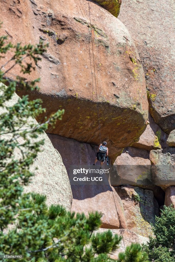 Man rock climbing in the Vedauwoo Recreation Area of Medicine Bow National Forest in Wyoming