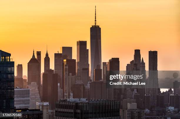 sunset view of lower manhattan - nyc skyline silhouette stock pictures, royalty-free photos & images