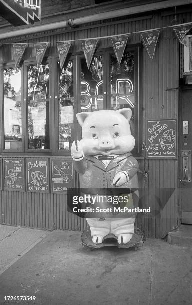 View of a porcine mascot outside Rudy's Bar & Grill in Hell's Kitchen, New York, New York, July 12, 2001.