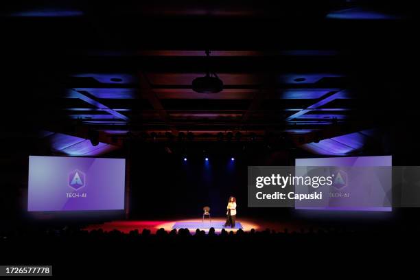 woman giving a speech in a conference - auditorium stock pictures, royalty-free photos & images