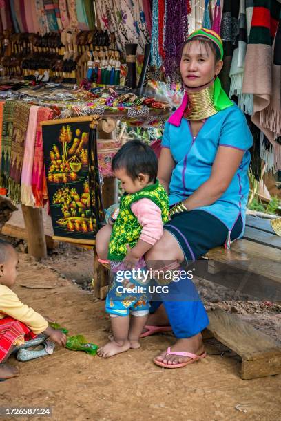 Tribal woman with two children in the Long Neck Karen tribe area of the Union of Hill Tribe Villages outside of Chiang Rai in the Nanglae District of...