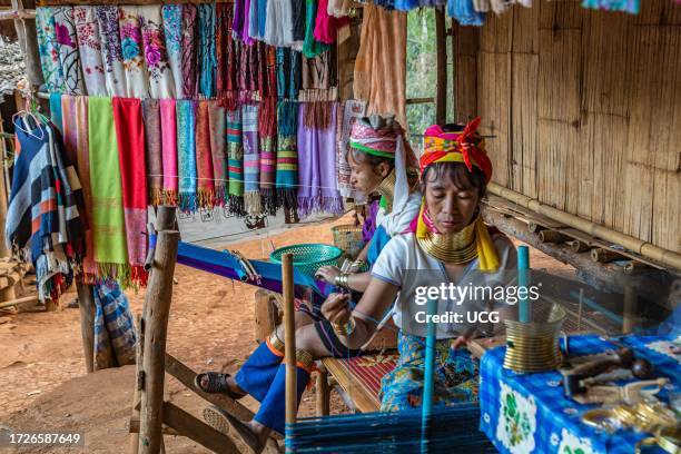 Tribal women weaving scarves to be sold in the Long Neck Karen tribe area of the Union of Hill Tribe Villages outside of Chiang Rai in the Nanglae...