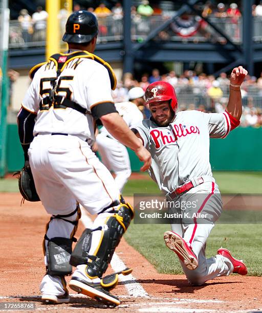 Kevin Frandsen of the Philadelphia Phillies scores on a fielder's choice in the sixth inning against the Pittsburgh Pirates during the game on July...