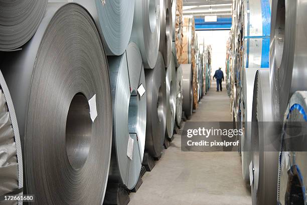 floor with rolls of sheet steel - iron roll stockfoto's en -beelden