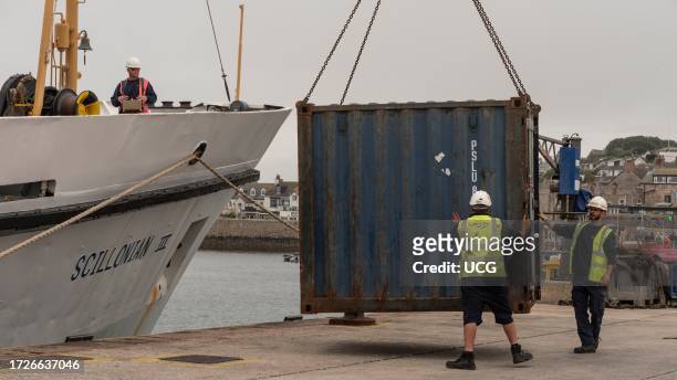 Hugh Town, St Marys, Isles of Scilly, UK, Unloading a metal container by crane from deck of the ferry Scillonian III arrival from the mainland.