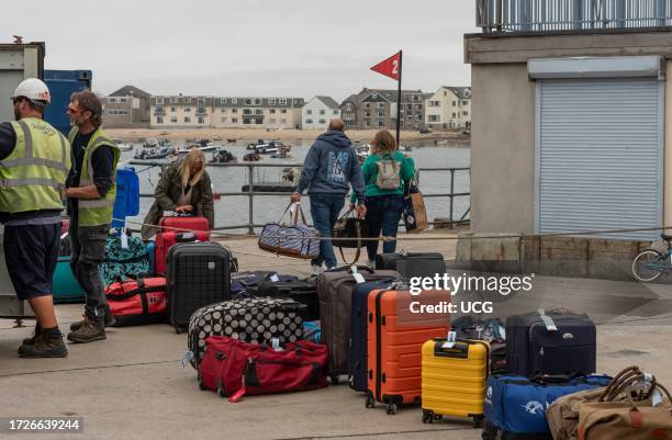 Hugh Town, St Marys, Isles of Scilly, UK, Ferry passengers luggage being sorted on the quay of Hugh Town, St Marys, Scilly Isles a holiday resort 26...