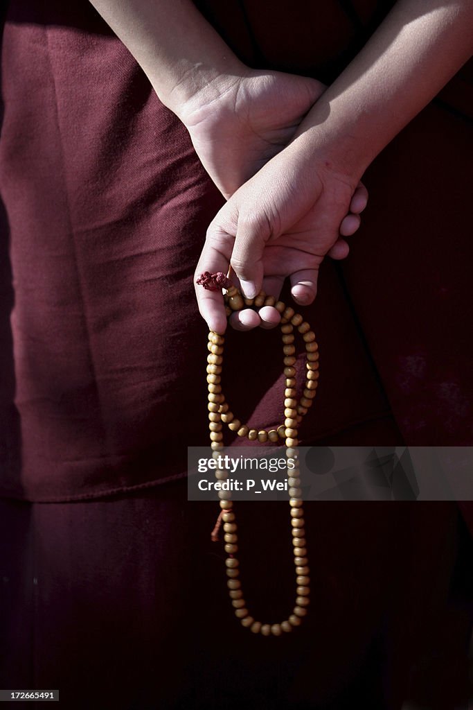 Prayer Beads in the hands of a monk
