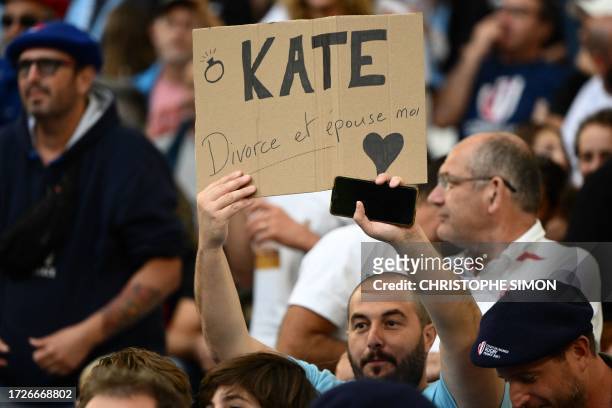 Rugby fan holds a placard reading "Kate, get divorced and marry me" during the France 2023 Rugby World Cup quarter-final match between England and...
