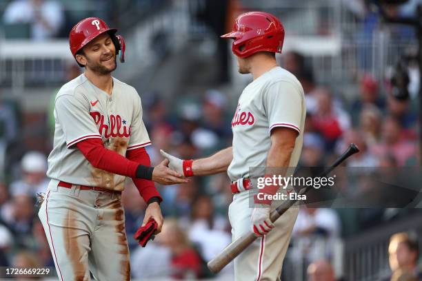 Trea Turner of the Philadelphia Phillies celebrates with J.T. Realmuto after scoring in the first inning against the Atlanta Braves during Game Two...