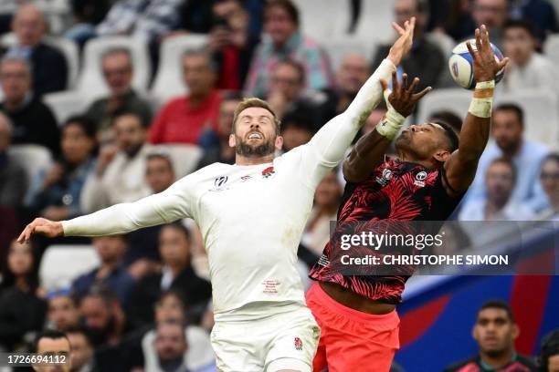 England's left wing Elliot Daly and Fiji's full-back Ilaisa Droasese jump for the ball during the France 2023 Rugby World Cup quarter-final match...