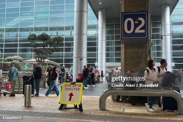 Shelter' sign is displayed near an entrance to the arrivals terminal at Ben Gurion Airport on October 09, 2023 in Lod, Israel. On Saturday, the...