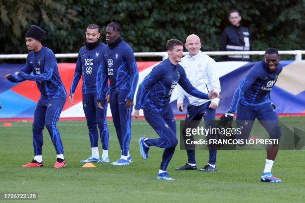 France's forward Marcus Thuram and France's defender Benjamin Pavard take part in a training session ahead of the national team's friendly football...