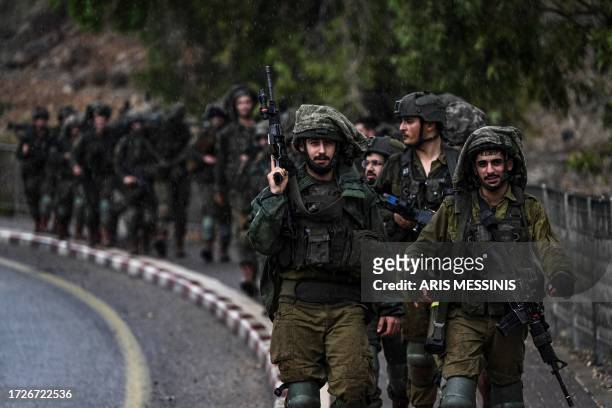 Israeli army soldiers patrol an undisclosed area in northern Israel bordering Lebanon on October 15 amid the ongoing battles between Israel and the...