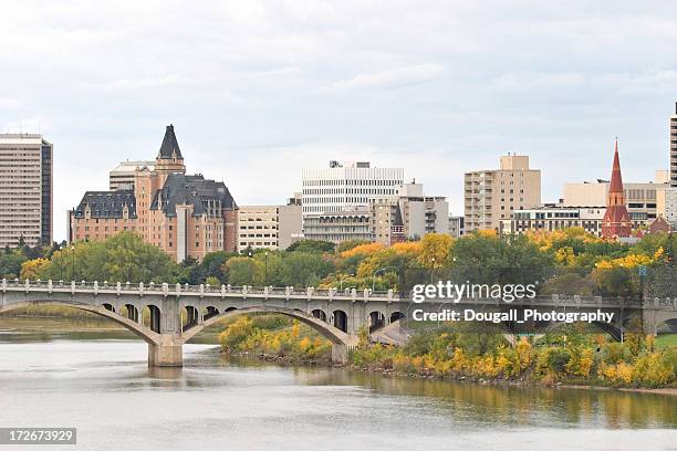 saskatoon downtown skyline with bridge hotels and condominiums - saskatoon stock pictures, royalty-free photos & images