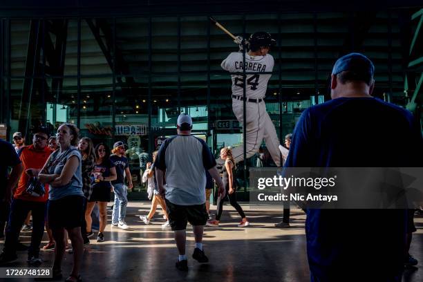 Fans walk past a decal featuring Miguel Cabrera of the Detroit Tigers during the game against the Cleveland Guardians at Comerica Park on October 01,...