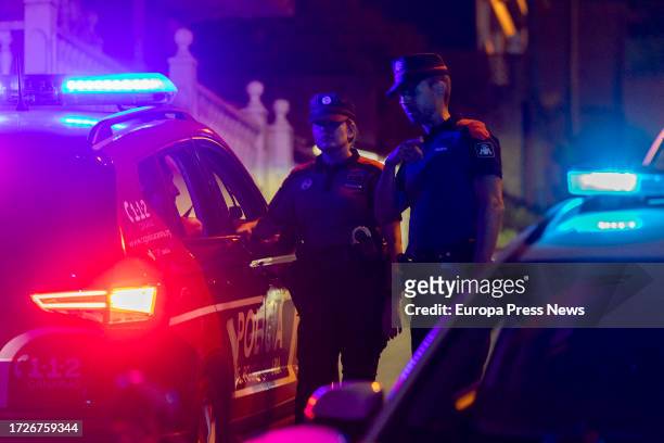 Two policemen on October 9 in El Sauzal, Tenerife, Canary Islands, Spain. A new reactivation of the Tenerife fire has forced to raise to emergency...
