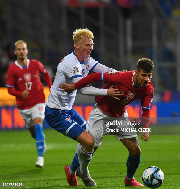 Czech Republic's forward Adam Hlozek fights for the ball with Faroes' defender Andrias Edmundsson during the UEFA Euro 2024 group E qualification...