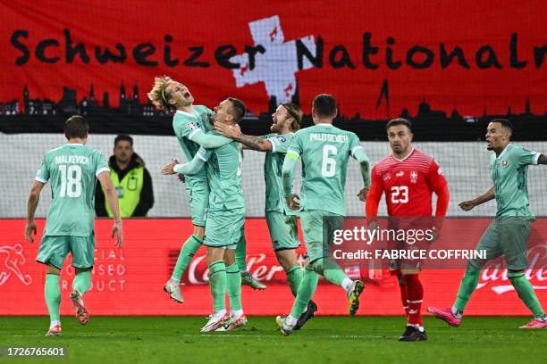 Belarus' players celebrates after scoring their team's second goal as Switzerland's midfielder Xherdan Shaqiri reacts during the UEFA Euro 2024...