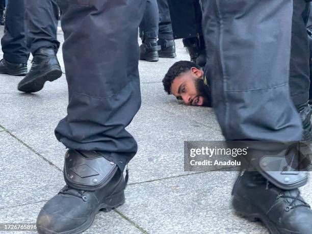 Police officers arrest a demonstrator as people gather to stage a demonstration in support of Palestinians in Berlin, Germany on October 15, 2023.