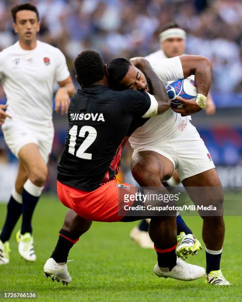 Manu Tuilagi of England is tackled by Josua Tuisova of Fiji during the Rugby World Cup France 2023 Quarter Final match between England and Fiji at...