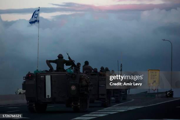 Israeli armored personnel carriers move in formation near the border with Lebanon on October 15, 2023 in Amiad, Israel. Israel has sealed off Gaza...