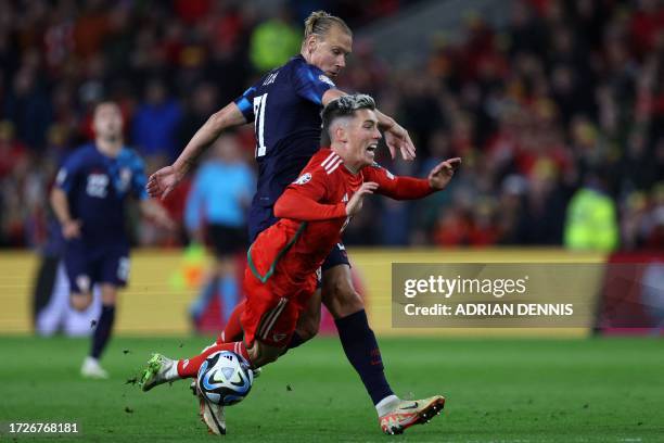 Croatia's defender Domagoj Vida fouls Wales' midfielder Harry Wilson during the UEFA Euro 2024 group D qualification football match between Wales and...