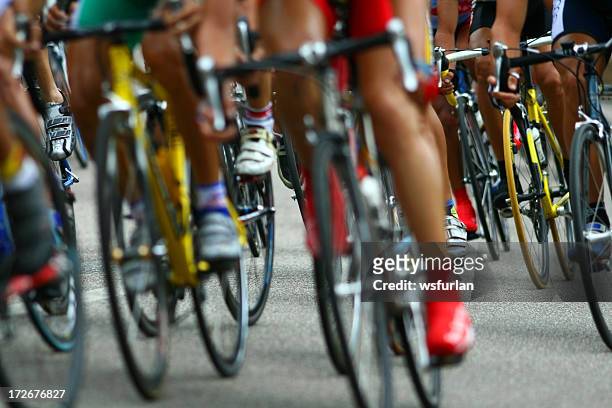 close-up of the legs of a group of cyclists in a competition - beginner triathlon stock pictures, royalty-free photos & images